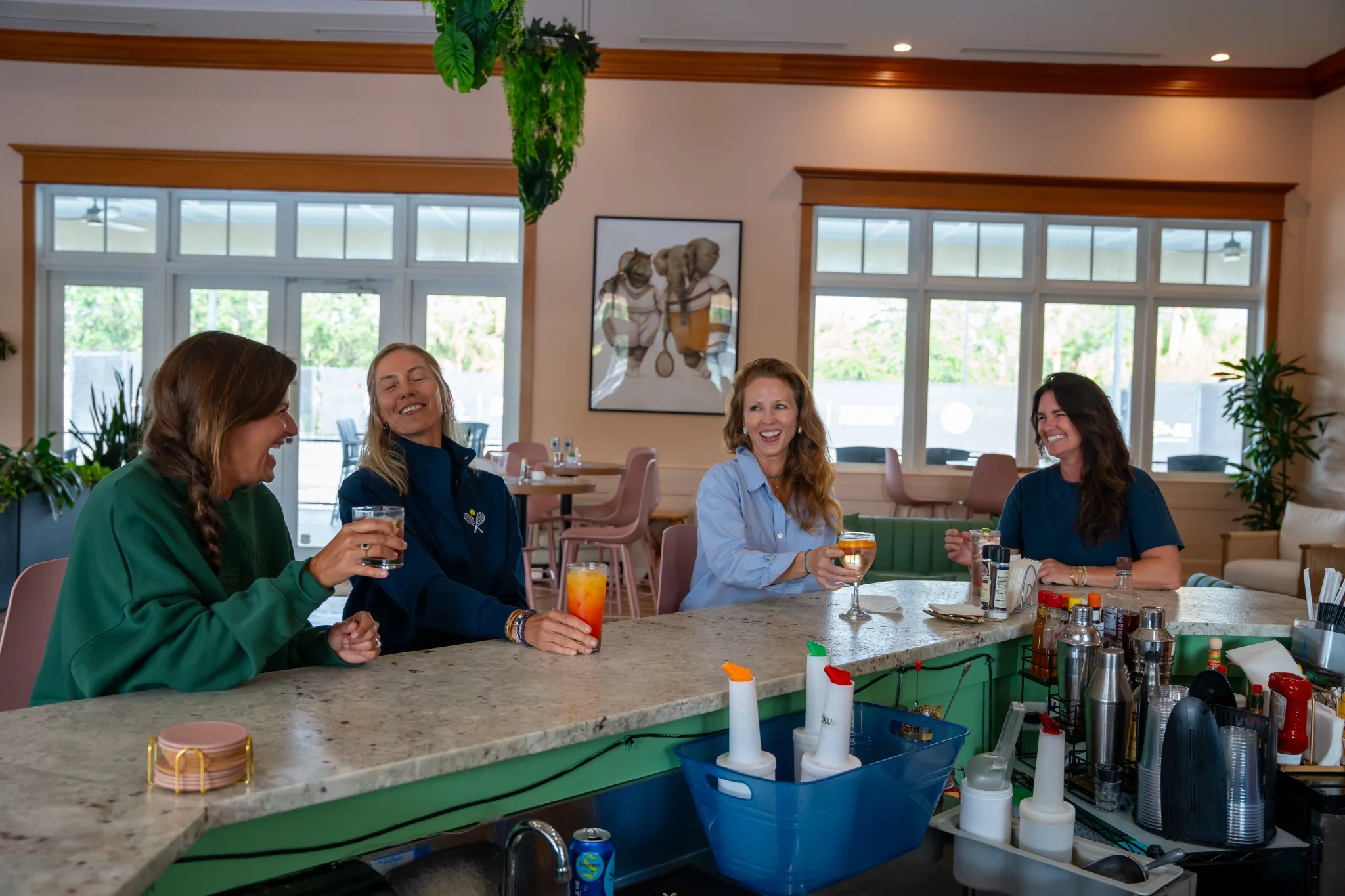 Friends enjoying drinks together at The Padel Grille bar